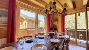 a dining room with a table and a large window at Chalet MON FRERE in Le Biot