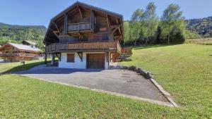 a large wooden house in the middle of a field at Chalet MON FRERE in Le Biot