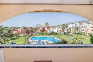 a view of the pool from the window of the apartment at Exclusive Alamos Beach in Torremolinos