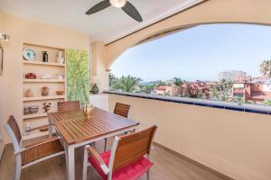 a dining room with a table and chairs and a window at Exclusive Alamos Beach in Torremolinos
