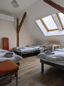 a room with three beds and a skylight at Dębina30 - Naturalnie odpoczniesz in Gorzów Śląski