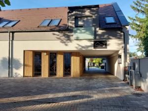 an entrance to a building with a garage at Linden Apartman 001 - Adults Only in Mosonmagyaróvár