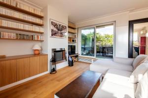 a living room with a couch and a fireplace at Veeve - Eiffel Exuberance in Paris