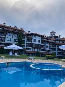 a swimming pool in front of a large building at Studio Stankovic Royal Towers 326 in Bansko