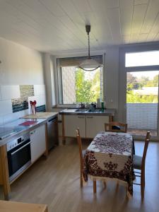 a kitchen with a table and a dining room at 2Schlafzimmer, Wohnküche&Balkon in Oberhausen