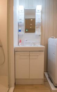 uma casa de banho com um lavatório e um frigorífico em Stayhome Osaka 4ppl House 2min-Station 2stop-Namba em Osaka