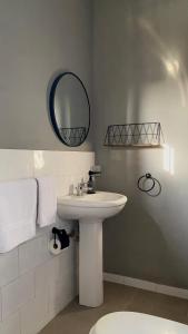 a bathroom with a white sink and a mirror at Home4u Fidji F2 in Cotonou