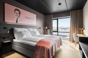 a bedroom with a large bed and a large window at Hotell Jæren in Bryne