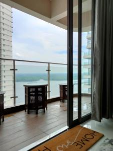 a room with a balcony with a view of the water at 2 Seaview Balcony@Danga Bay in Johor Bahru