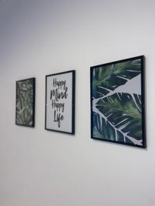drie ingelijste foto's aan een muur in een kamer bij Rock Lane House by Serviced Living Liverpool in Rock Ferry