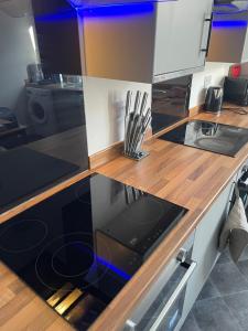 a kitchen with a counter with a stove top oven at Rock Lane House by Serviced Living Liverpool in Rock Ferry