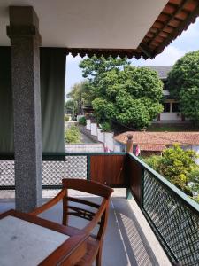 a balcony with a table and a view of a street at Dalem Arum (for women only) in Bandung
