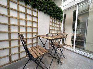 a table and two chairs on a patio at Dos Torres Tenor Gayarre - Encanto con Balcón Interior in Zaragoza