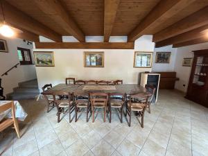 a large dining room with a table and chairs at Casa Salada in Bagnolo Piemonte