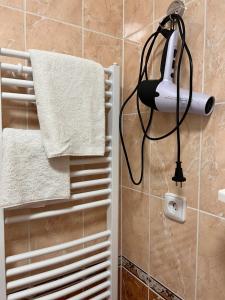 a white towel hanging on a wall in a bathroom at Jurincom apartmens Zamecky Vrch in Karlovy Vary