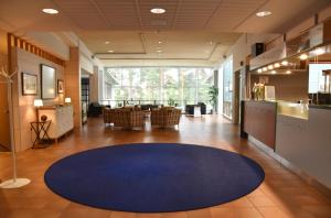 a large lobby with a blue rug on the floor at Saimaanranta Resort by Anttolanhovi in Mikkeli +77 photos