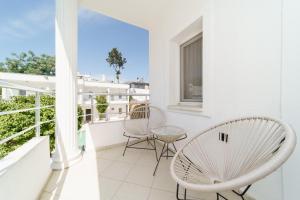 a balcony with two chairs and a table at Costa Maya Bodrum in Bodrum City