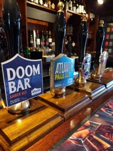 a bar with two bottles of beer on a counter at The Bugle Inn in Southampton