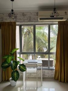 a desk in a room with a large window at Boutique Room in Koregaon Park. WiFi, Ac, Smart Tv in Pune