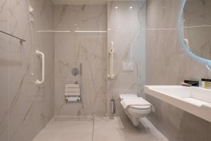 a bathroom with a shower and a toilet and a sink at GRAND PATELLI in Myrina