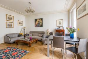 a living room with a table and a couch at Veeve - Ambassador Hideaway in Paris