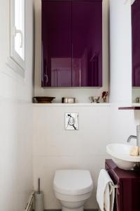 a bathroom with a toilet and a sink at Veeve - Ambassador Hideaway in Paris