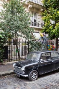 a black car parked in front of a fence at Veeve - Ambassador Hideaway in Paris