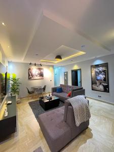 a living room with a couch and a table at Cadoxa apartment in Lagos