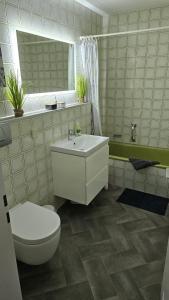 a bathroom with a white toilet and a sink at Ferienwohnung deine Auszeit im Allgäu in Missen-Wilhams