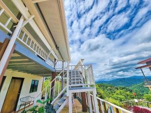 a staircase on the side of a house with a view at ดอยตุง สันติสุขโฮมสเตย์ in Ban Pa Kluai La Hu