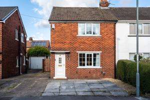 a red brick house with a white door at Alexandra - WiFi Parking Garden in Walton le Dale