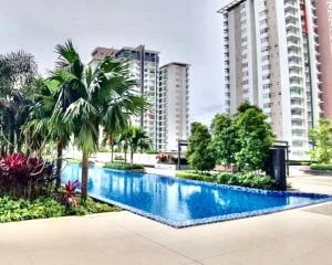 a large swimming pool with palm trees and buildings at Putra Homestay, Presint 15, Near Alamanda Mall & Presint Diplomatik in Putrajaya