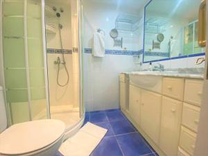 a bathroom with a shower and a toilet and a sink at Salinetas, frente al mar y playa in Telde +26 photos