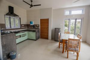 A kitchen or kitchenette at singing greenz staycations