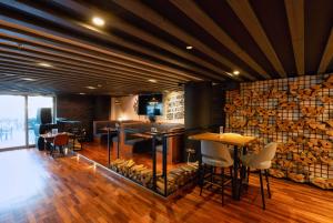 a restaurant with a bar with tables and chairs at The First Collection Dubai Marina in Dubai