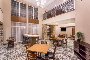 a restaurant with tables and chairs in a room at Wyndham Garden Madison Fitchburg in Madison