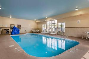 a large pool with blue water in a building at Quality Inn & Suites Delaware in Delaware