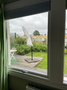 a window with a white umbrella on a deck at Cozy Rooms between Airport&Center in Stockholm