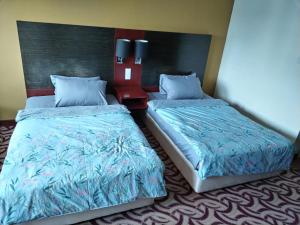En eller flere senge i et værelse på South China Sea Place Suites at Ming Garden, near Imago, Sutera Avenue KK