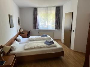 a bedroom with two beds and a window at Hotel am Stimbergpark in Oer-Erkenschwick