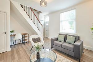 a living room with a couch and a table at Host & Stay - Dove Cottage in Bearpark