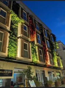 a building with plants on the side of it at Mariposa Hotel Malaga in Málaga
