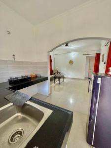 a kitchen with a stainless steel sink in a room at Sober 2bhk Pet Friendly Apartment with pool view in Marmagao