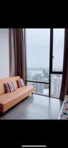 a couch in a room with a large window at Studio Tower @ Empire Damansara in Petaling Jaya