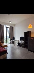 a living room with a couch and a television at Studio Tower @ Empire Damansara in Petaling Jaya