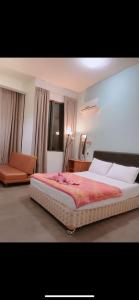 a bedroom with a large bed and a couch at Studio Tower @ Empire Damansara in Petaling Jaya