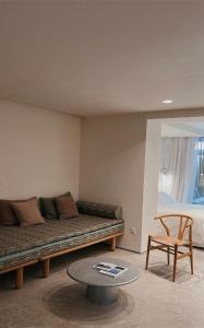 a living room with a couch and a table at Ekies All Senses Resort, a Member of Design Hotels in Vourvourou