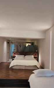 a bedroom with a large bed with a large mirror at Ekies All Senses Resort, a Member of Design Hotels in Vourvourou