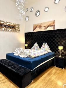 a bedroom with a bed with a blue bedvisor at Sisi Apartment in Vienna