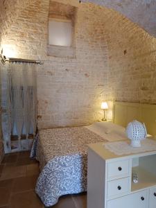 A bed or beds in a room at Trulli D'Angiò